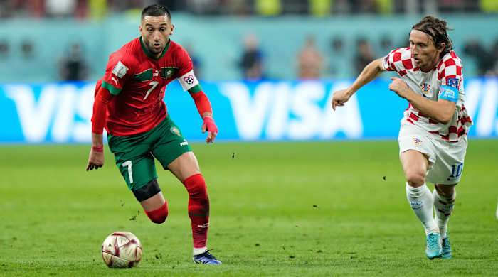 Morocco’s Hakim Ziyech chases after the ball along with Croatia’s Luka Modrić at the World Cup.